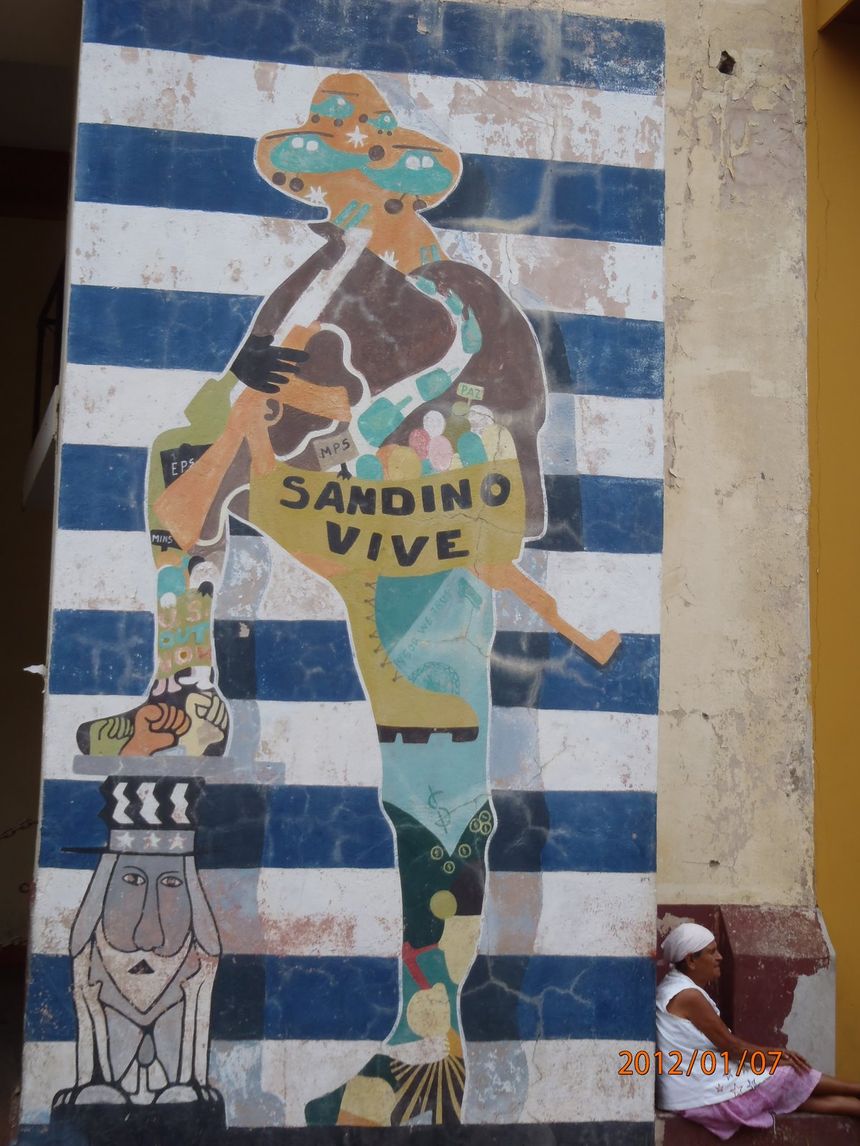 Mural I. Rewolucjonista gniecie butem, podłego kapitalistę z USA. Ziem bez ziemi