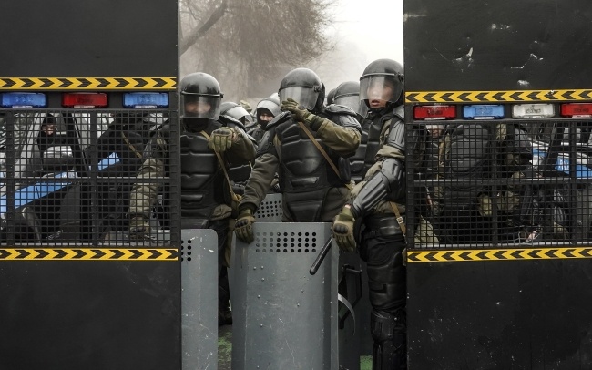 Policjanci blokują ulicę podczas wiecu protestacyjnego w sprawie podwyżki cen energii w Ałmaty, fot. PAP/EPA