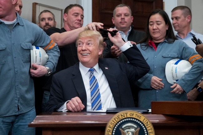 Donald Trump w trakcie podpisywania decyzji o cłach na stal i aluminium. Fot. PAP/EPA