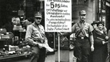 The sign reads: “Germans, Attention! This shop is owned by Jews. Jews damage the German economy and pay their German employees starvation wages. The main owner is the Jew Nathan Schmidt.” (1st April, 1933)