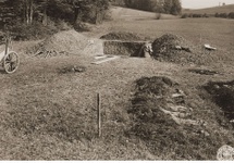 View of the mass grave near Hirzenhain from which the bodies of 87 prisoners were exhumed, similar to ones found in Ukraine after the war. May 7, 1945. Image courtesy of the United States Holocaust Memorial Museum.