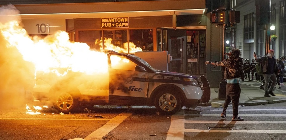 Podpalony radiowóz. W 40 amerykańskich miastach dochodzi do bijatyk z policją. Fot. PAP/EPA