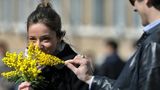 Getty images: A woman holds a bunch of mimosa in Rome on International Women's day 2012