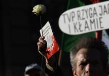 An activist holds a copy of the Polish Constitution during a march against Polish state television (TVP), protesting media manipulation and creation of a propaganda machine accused of favoring the Law and Justice (PiS) ruling party, in Warsaw on Feb. 17. 