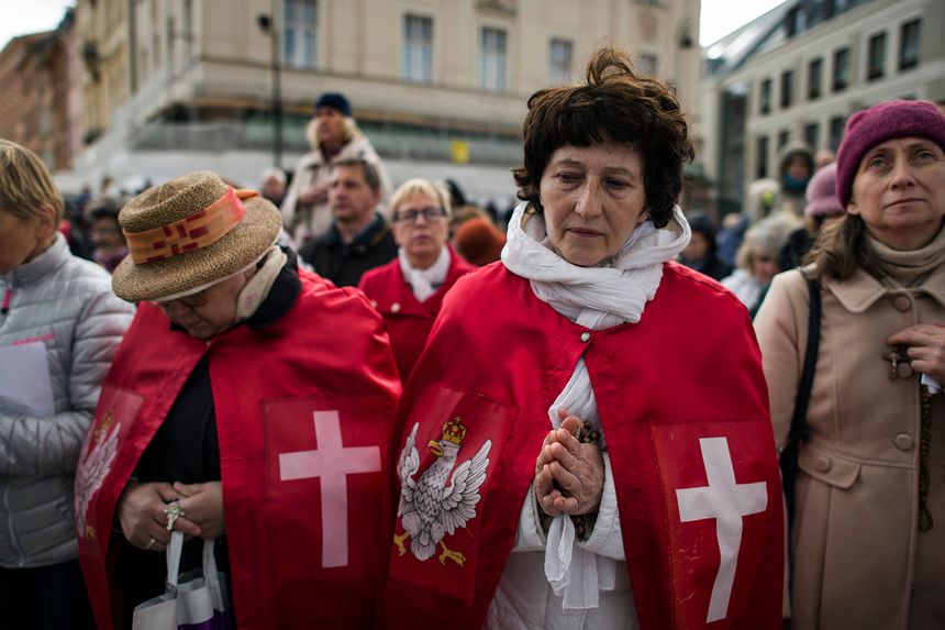 WARSAW, MAZOWIECKIE, POLAND - 2019/10/05: Women dressed in a crucifix cape with the Polish emblem are seen praying during the march.The National Rosary March took place in Warsaw with over 500 believers from all over Poland participated. The march is orga