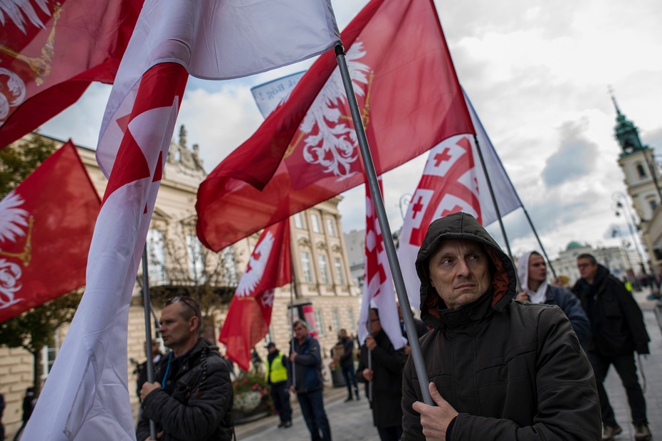 Participants hold flags during the National Rosary March organized by Poland’s Catholic Church and the governing Law and Justice (PiS) party in Warsaw on Oct. 5. Attila Husejnow/SOPA Images/LightRocket via Getty Images