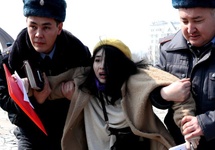 EPA  Police in Kyrgyz detained dozens of women's rights activists during a IWD march in 2020, shortly after masked men reportedly attacked marchers